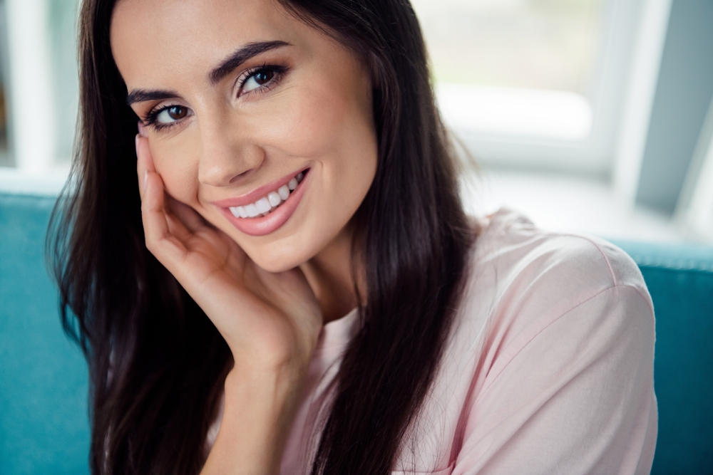 Woman with Bright Natural Smile and Healthy Teeth - Cosmetic Dentist Cupertino Close-up portrait of a woman with smooth, white teeth and a confident smile, showcasing the beautiful results possible with treatments from a cosmetic dentist in Cupertino - Cosmetic Dentist Cupertino