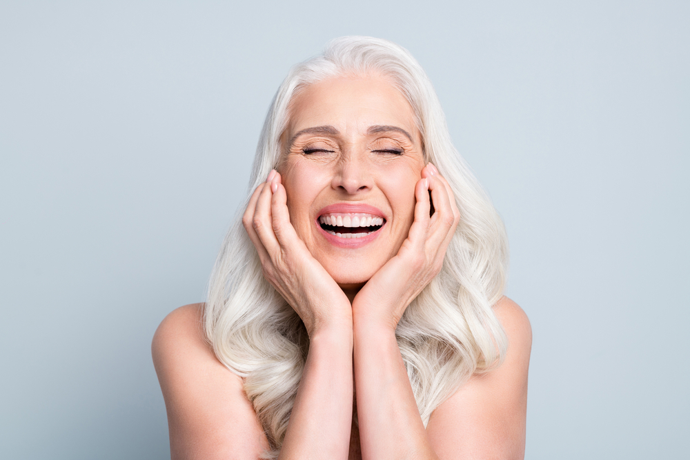 Portrait of a happy senior woman with healthy, well-aligned teeth, representing long-lasting strength and appearance restored through dental crown treatment in Cupertino - Dental Crown Cupertino