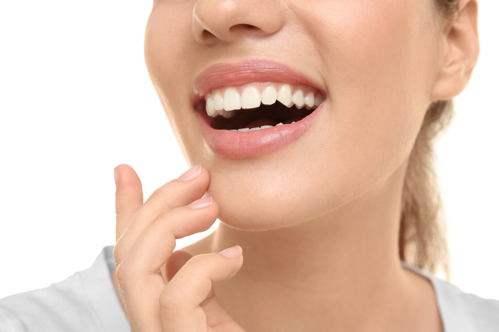 Detailed close-up of a woman’s bright, natural-looking teeth and smooth smile, highlighting the aesthetic and restorative benefits of a dental crown treatment in Cupertino - Dental Crown Cupertino